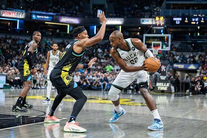 Milwaukee Bucks forward Khris Middleton (22) looks to dribble the ball while Indiana Pacers forward Bruce Brown (11)